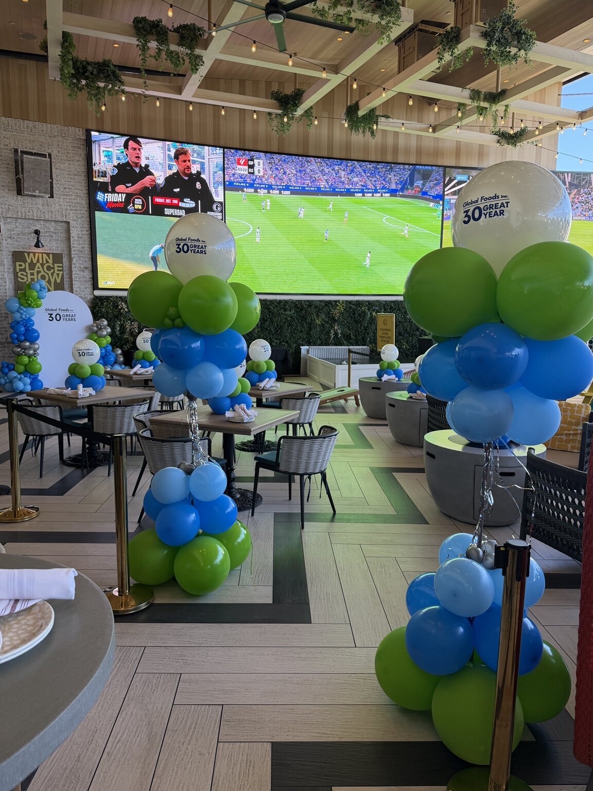 Global Foods 30th anniversary finale with branded balloon centerpieces throughout The George