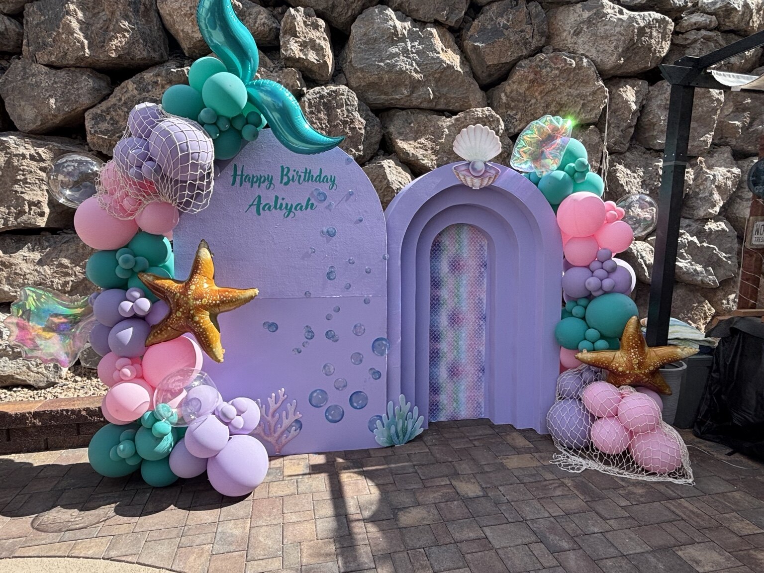 Under the Sea mermaid party backdrop with pastel balloons and ocean details